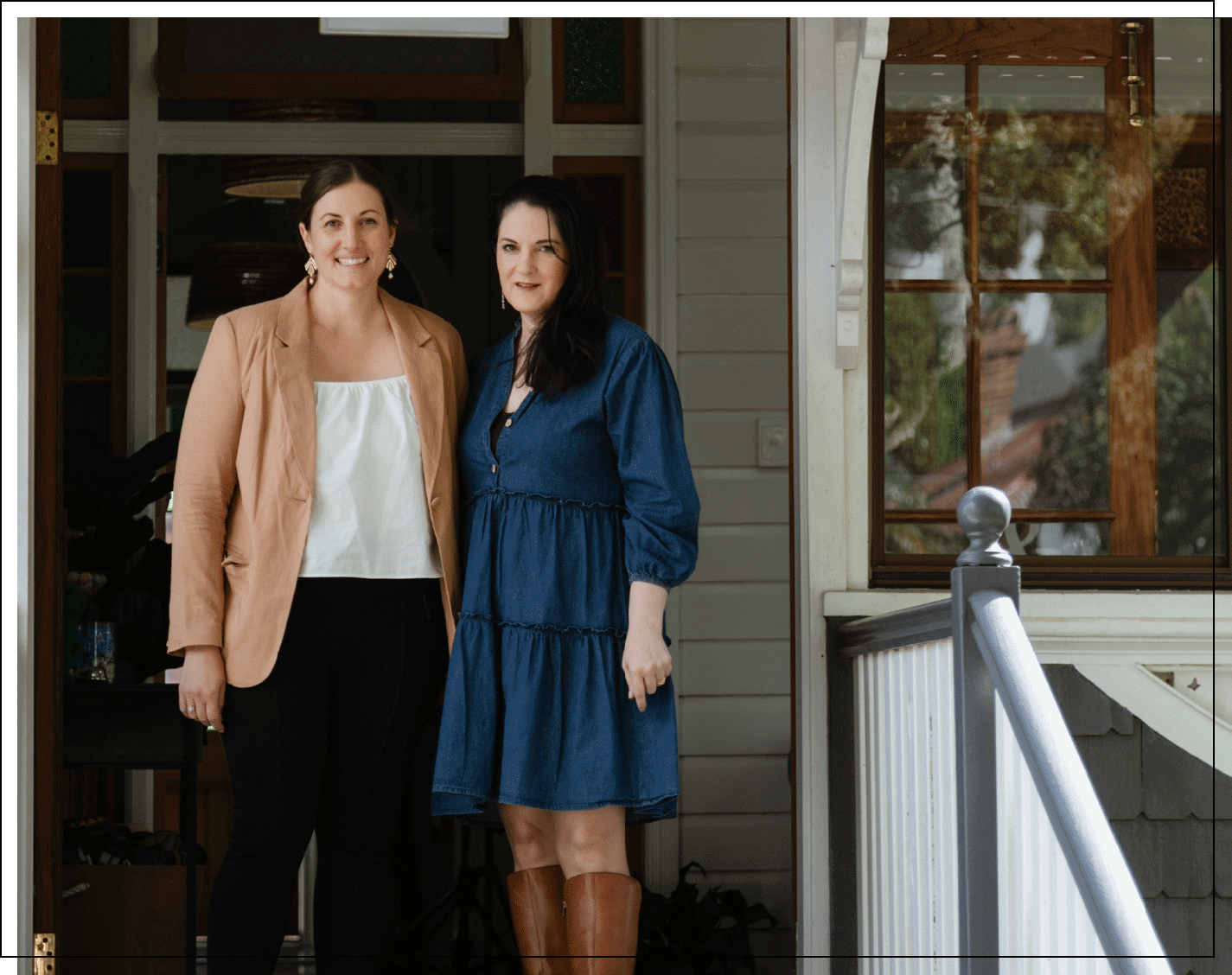 Anna and Kristy standing next to each other on the porch of Black Canvas