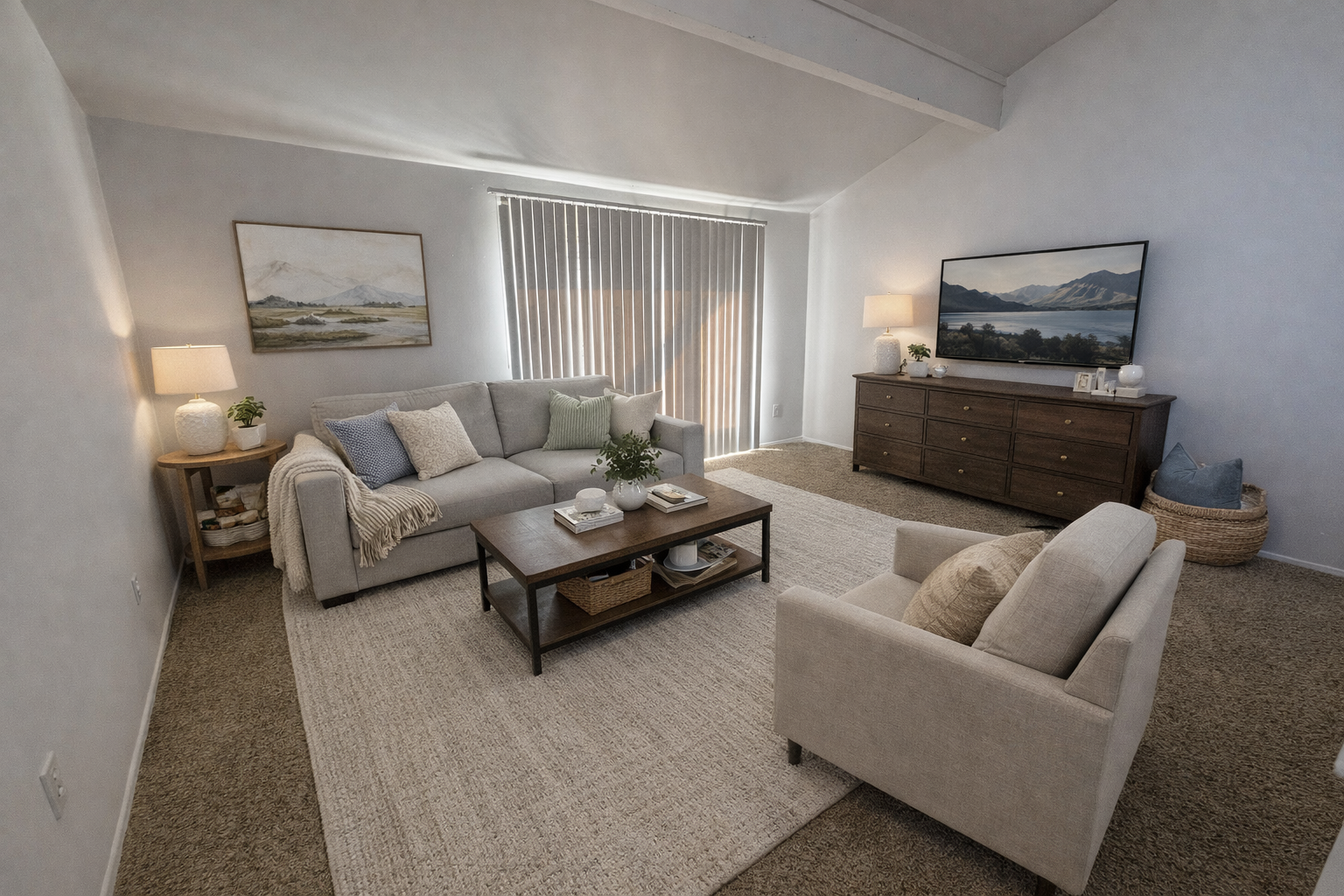 Living room with gray sofa, TV, and neutral decor.