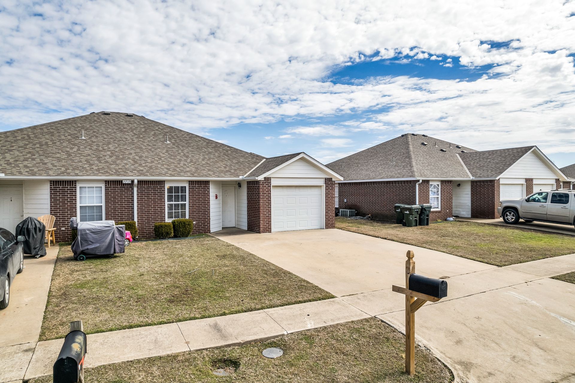A couple of houses with a mailbox in front of them.