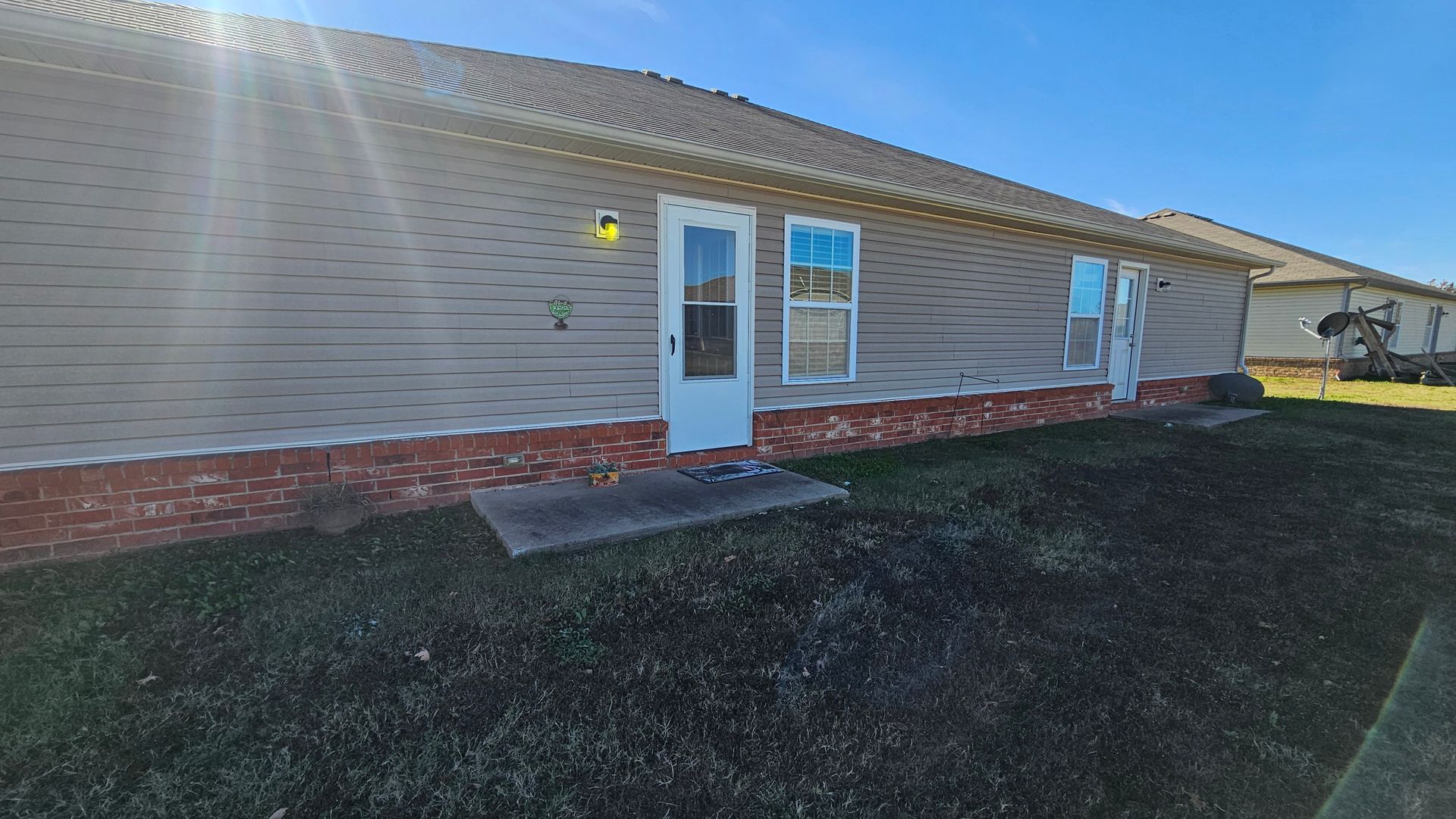 A house with a lot of windows and a sliding glass door.