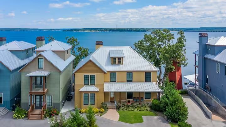 An aerial view of a row of houses next to a body of water.