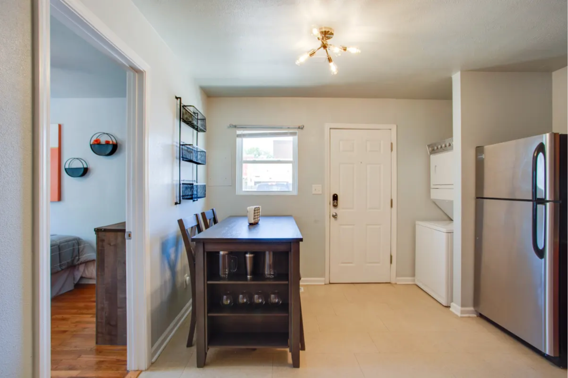 A kitchen with a table and chairs and a refrigerator