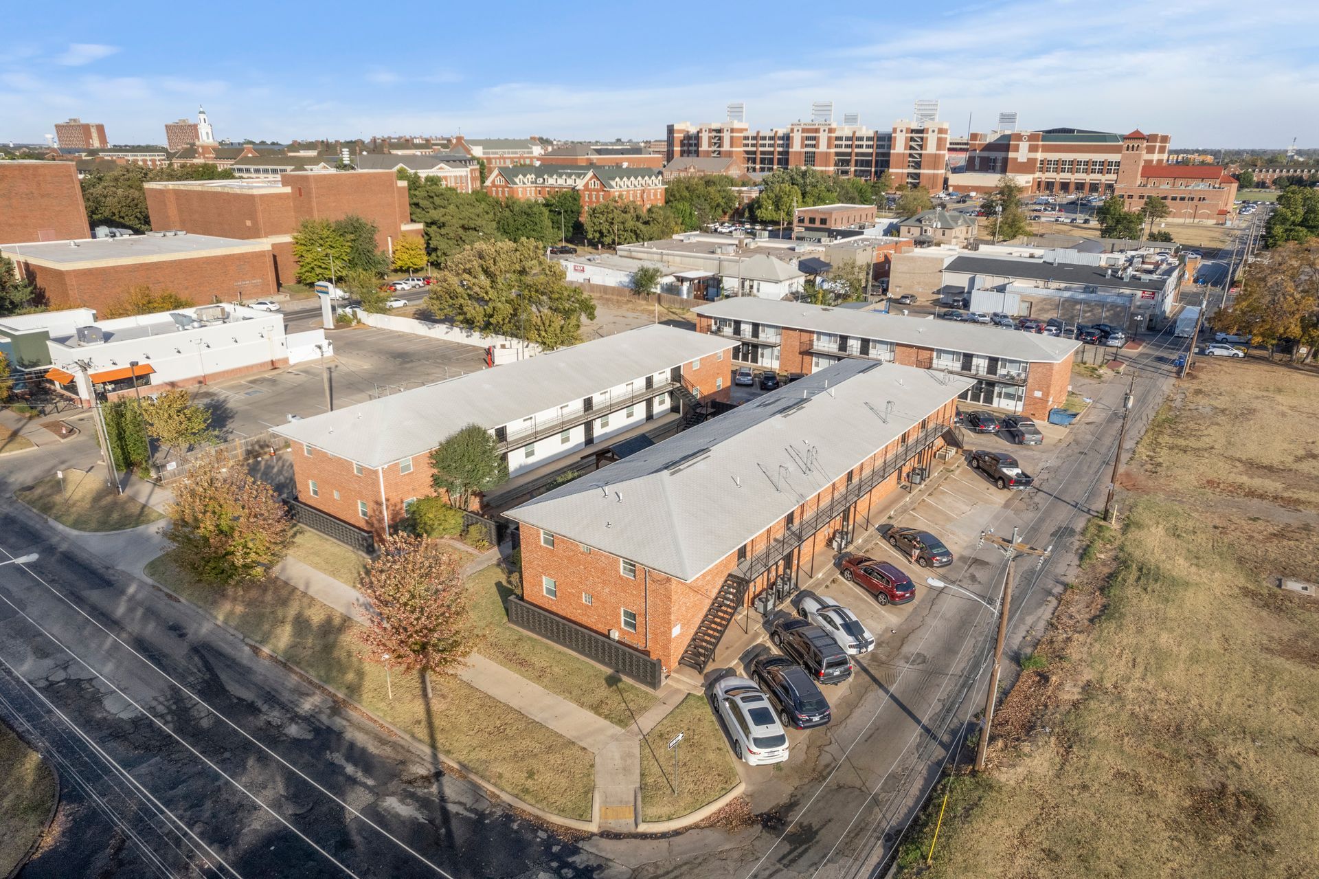 An aerial view of a building with cars parked in front of it.