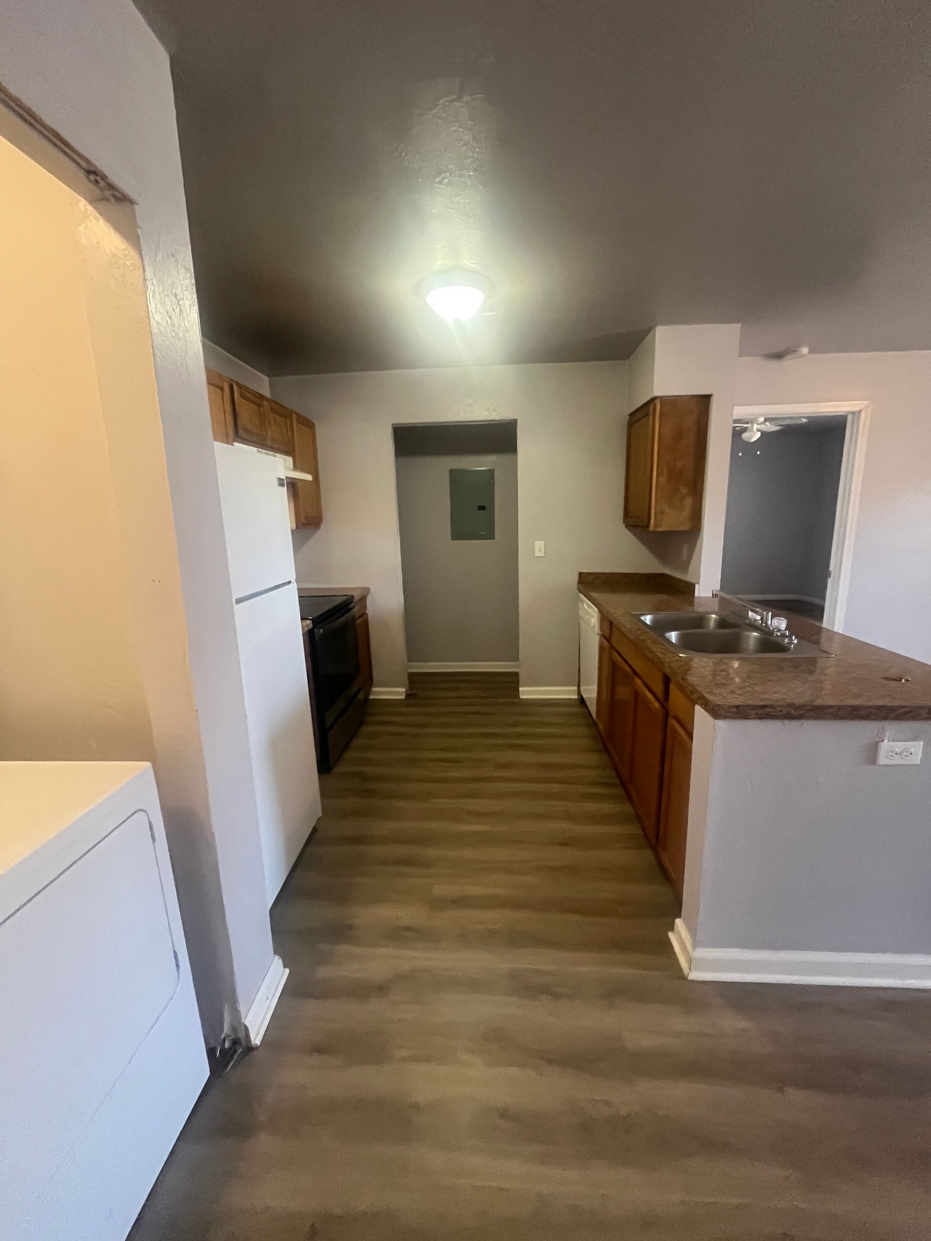 A kitchen with a refrigerator , sink , and stove.