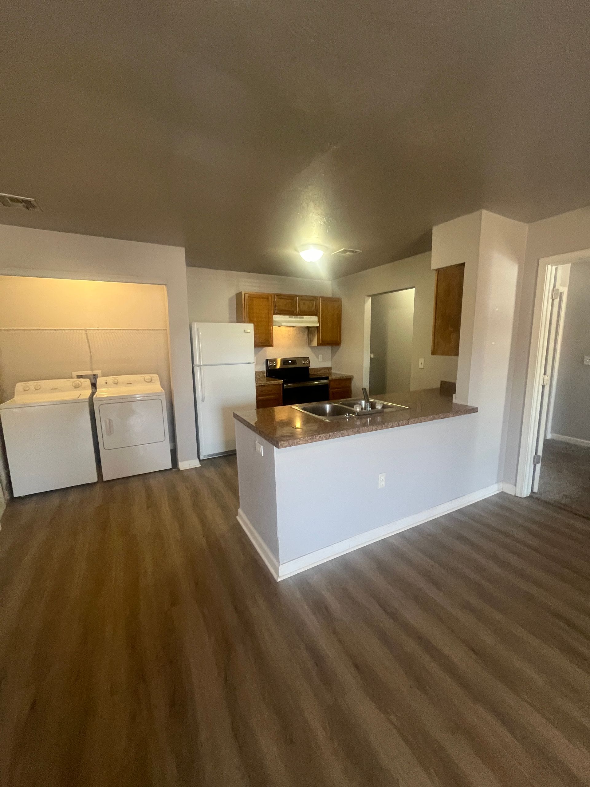 A kitchen with a refrigerator , stove , sink , and dishwasher.