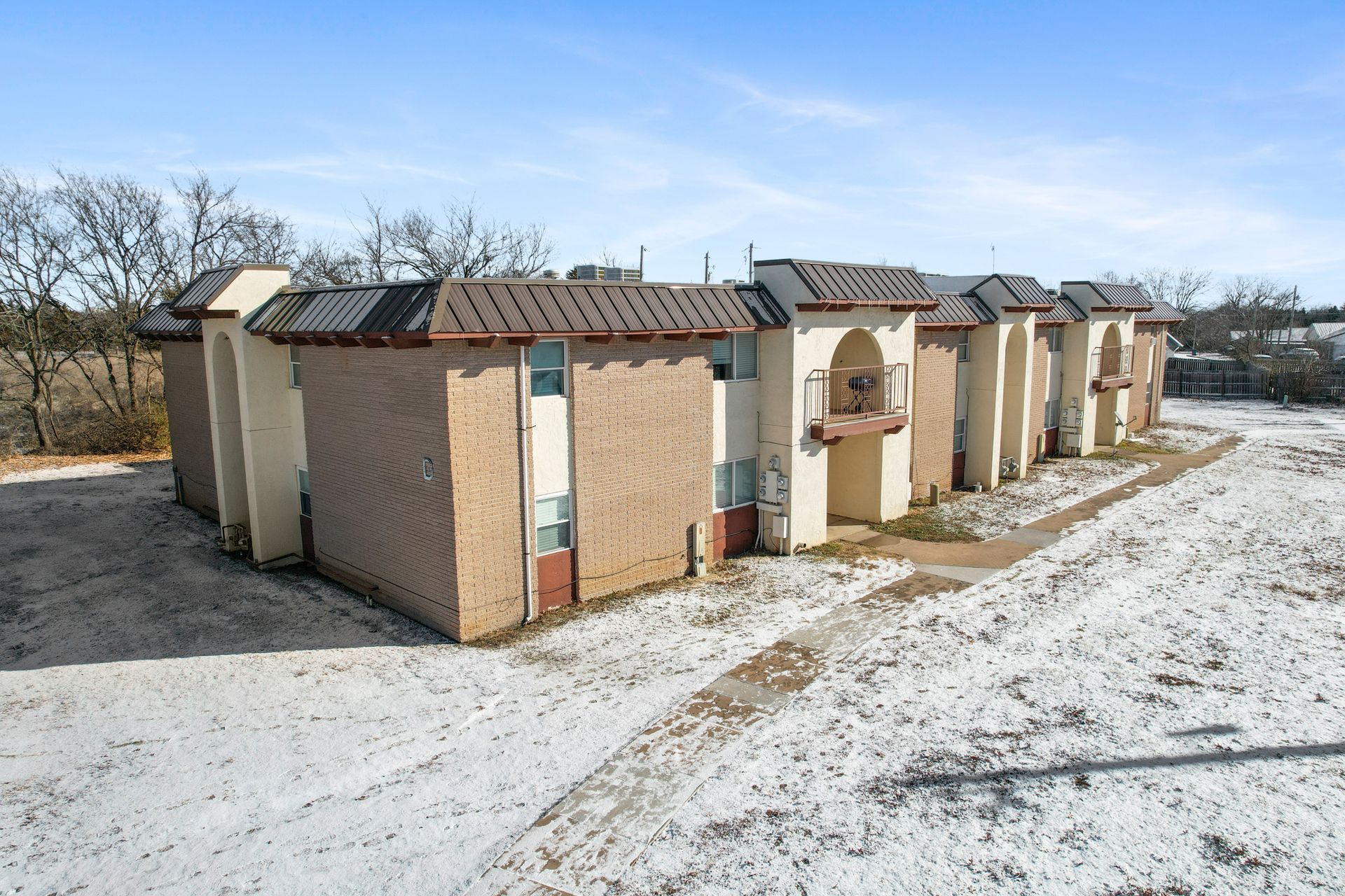 A row of buildings sitting on top of a snow covered field.