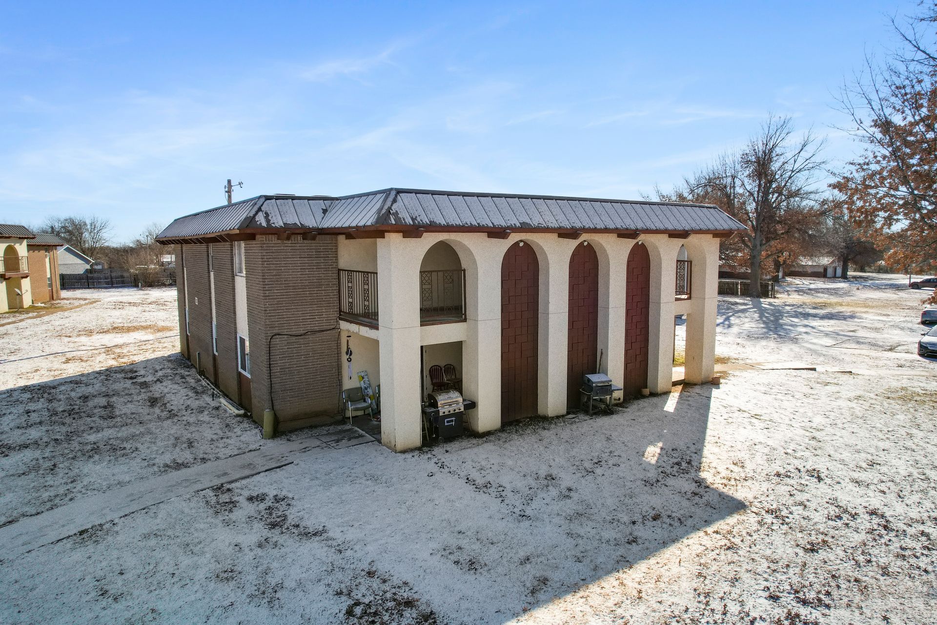 An aerial view of a house in the snow.
