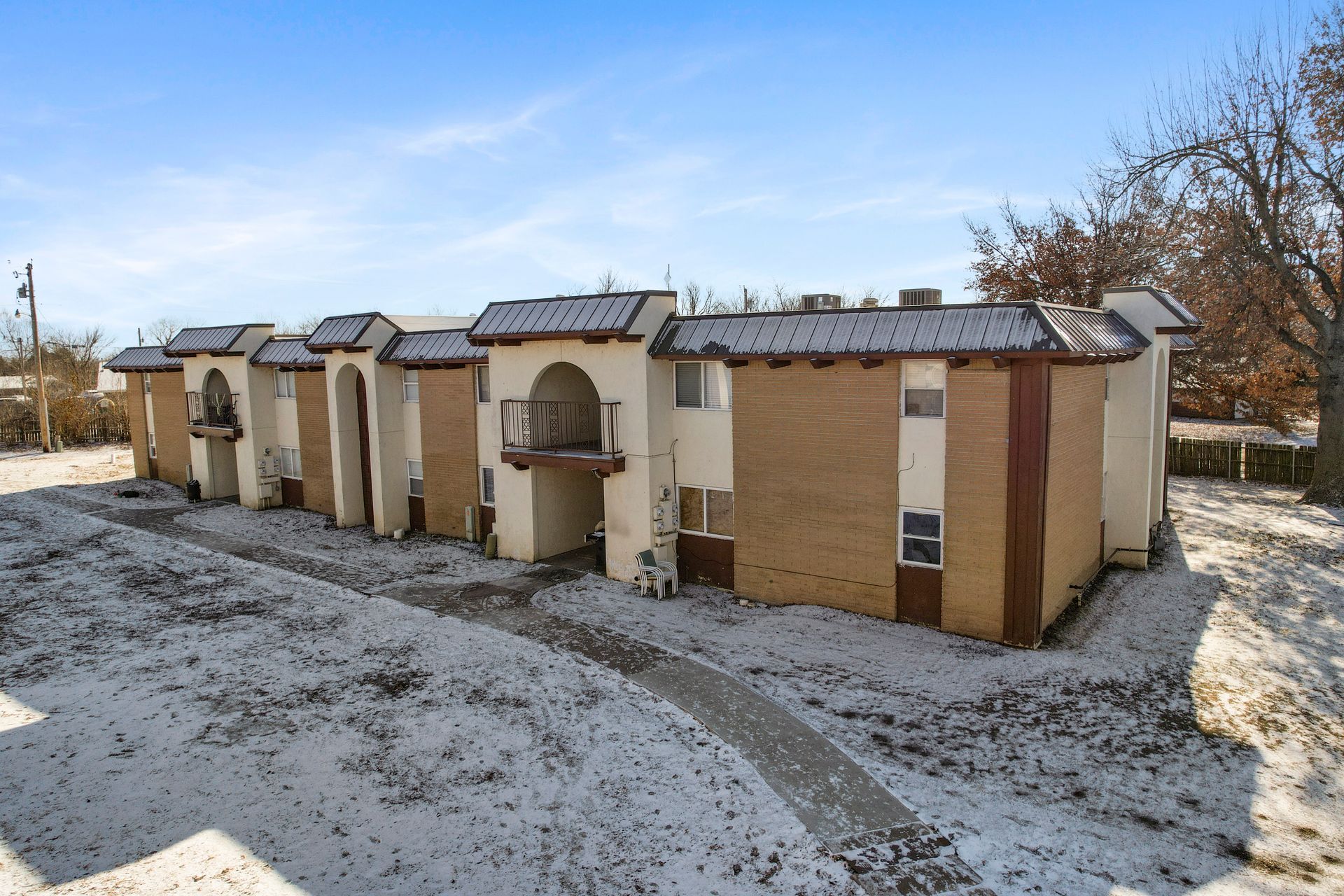 A row of apartment buildings with snow on the ground