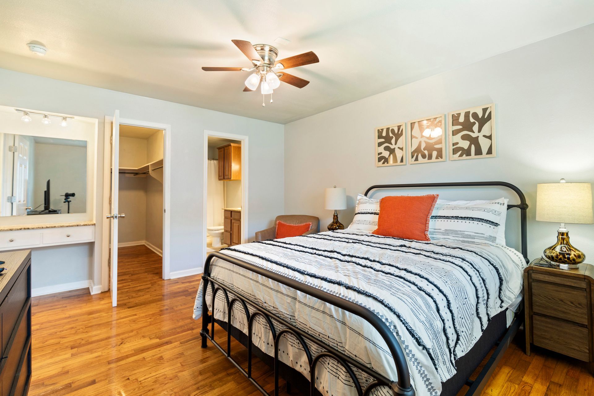 A bedroom with a king size bed and a ceiling fan.