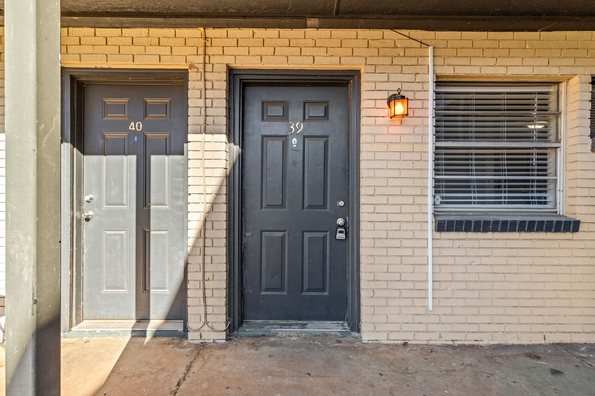 A brick building with two doors and a window