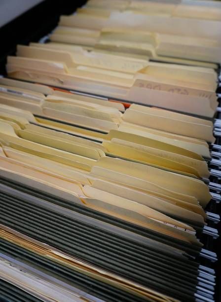 A close up of a filing cabinet filled with folders