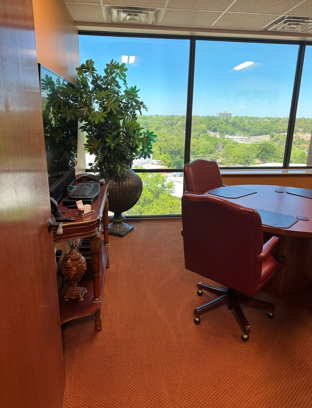 A conference room with a table and chairs and a large window