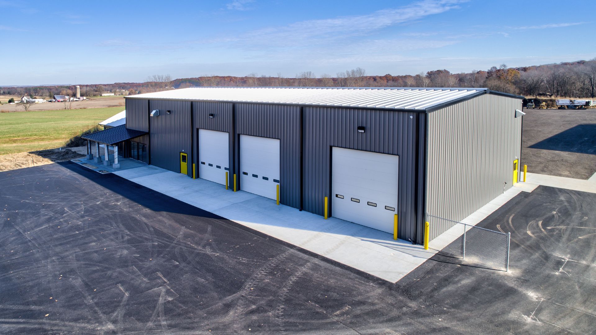 An aerial view of a large metal building with three garage doors.