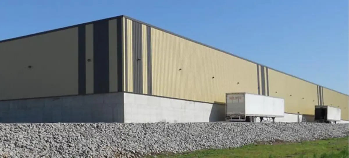 A large building with a truck parked in front of it.