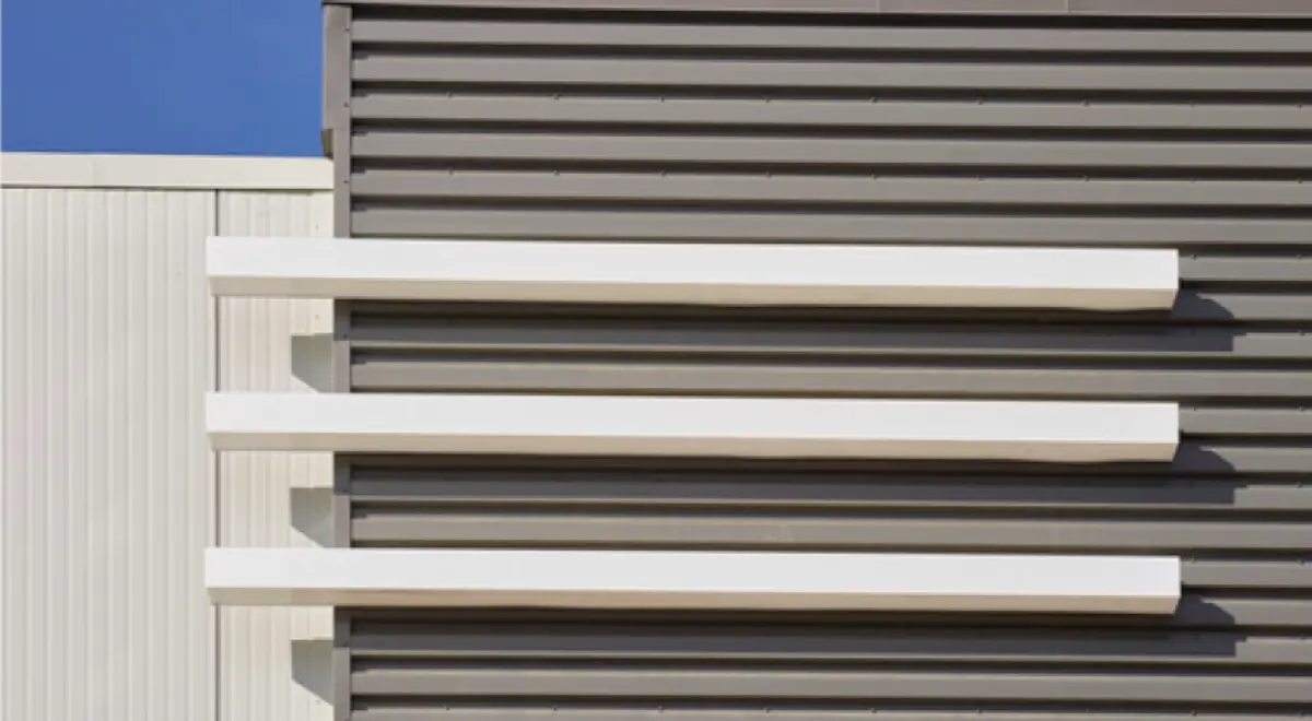 A close up of a building with a blue sky in the background.