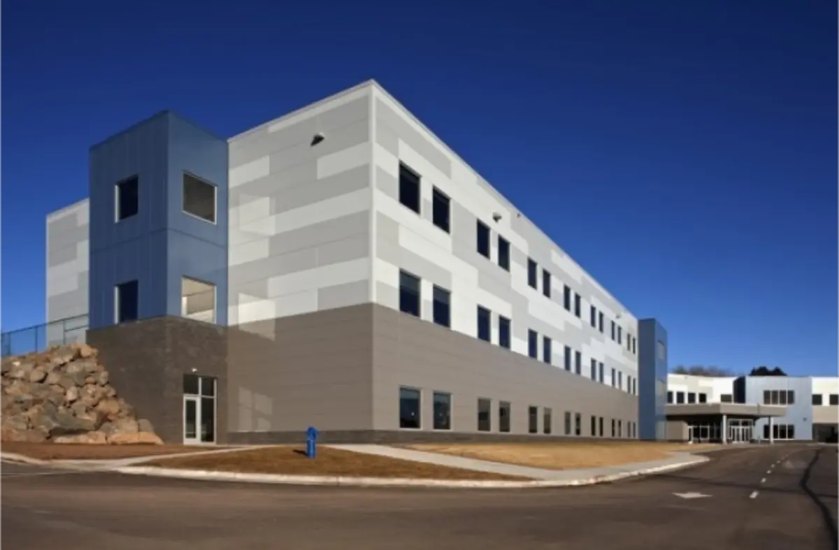 A large building with a blue sky in the background