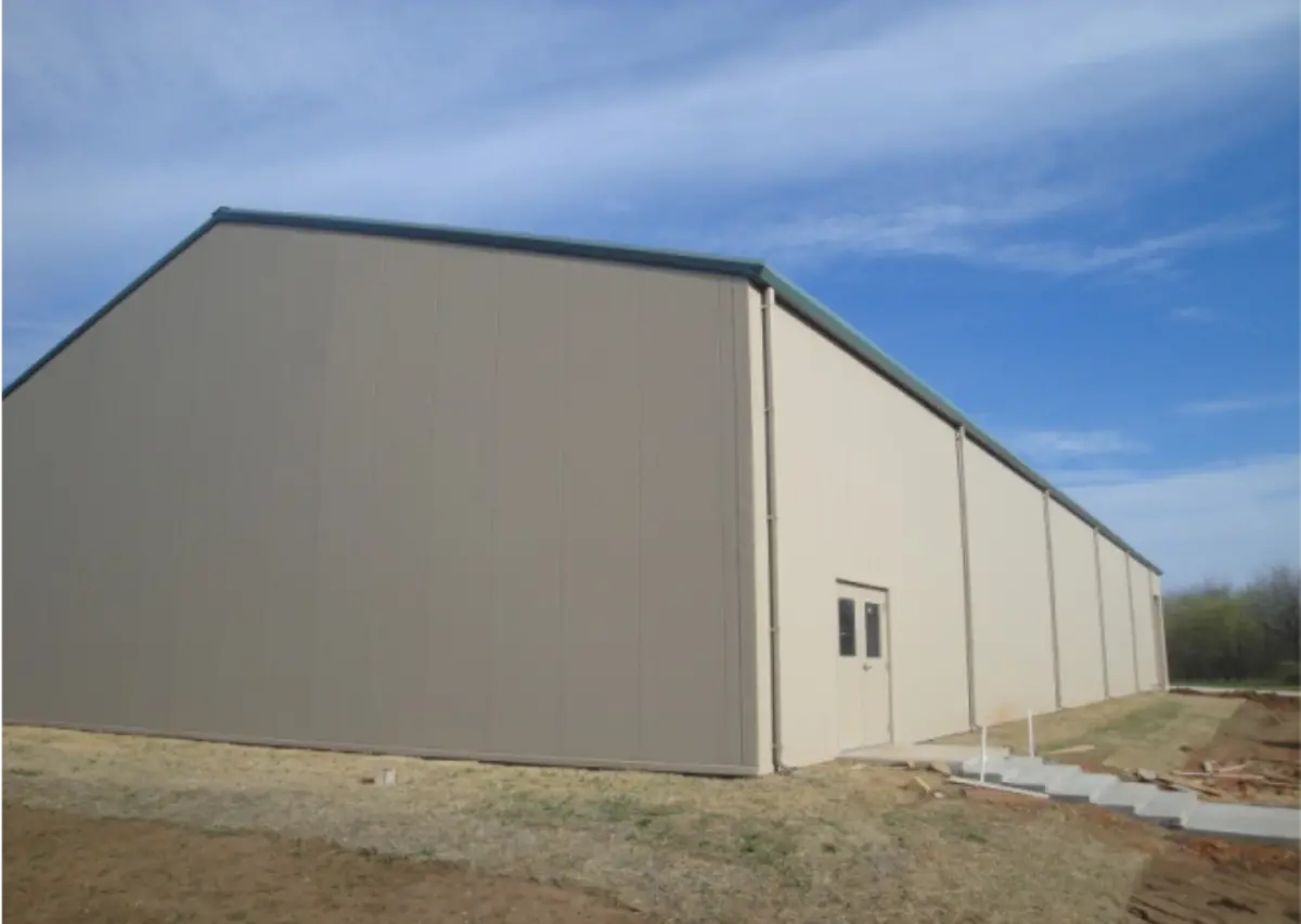 A large tan building with a green roof