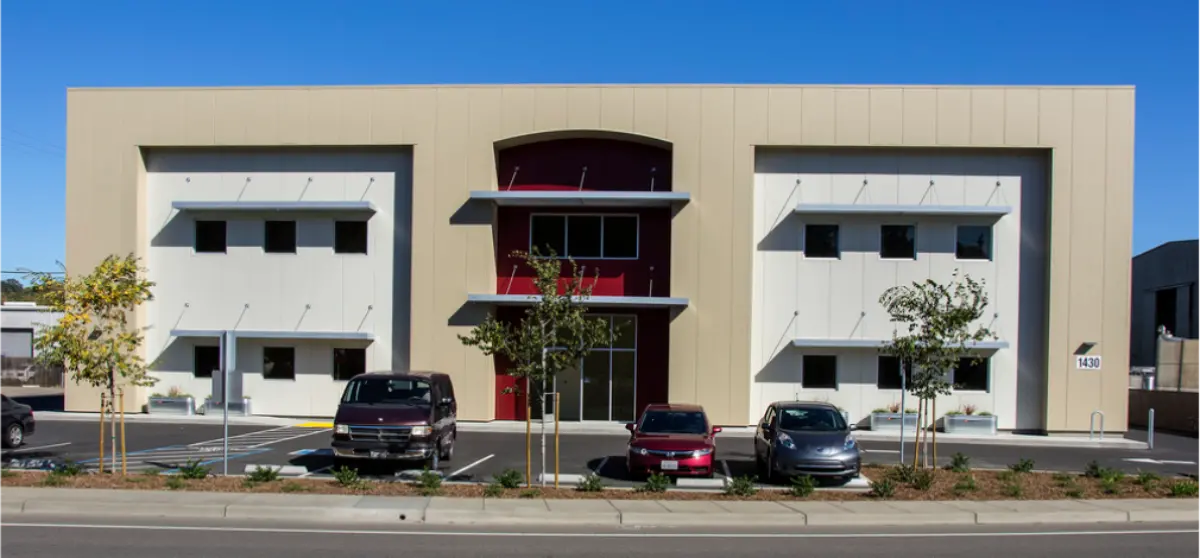 A large building with cars parked in front of it