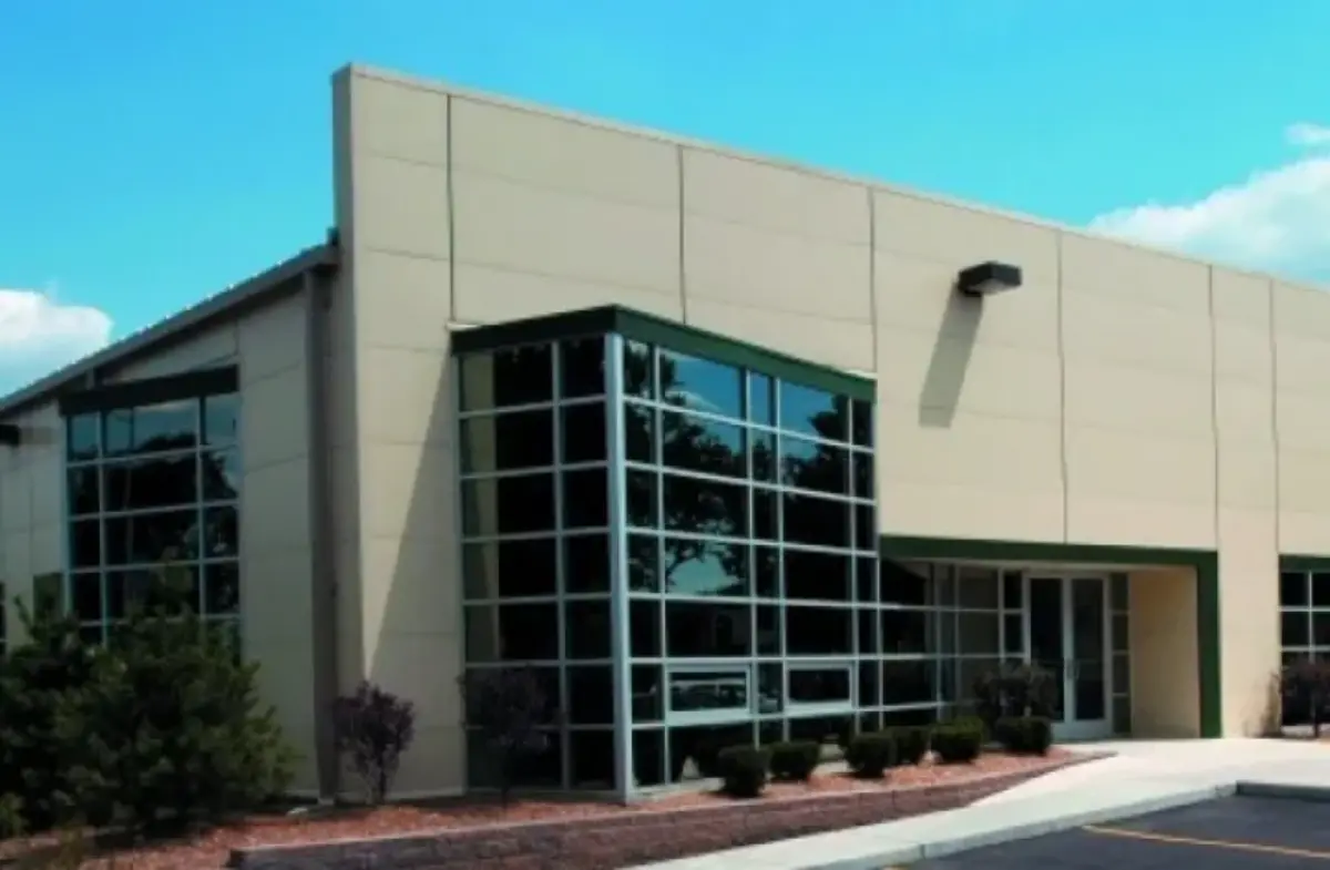 A large building with a lot of windows and trees in front of it