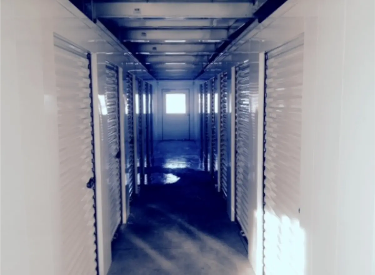 A hallway with a lot of doors and a window