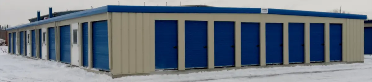 A large building with blue doors in the snow.