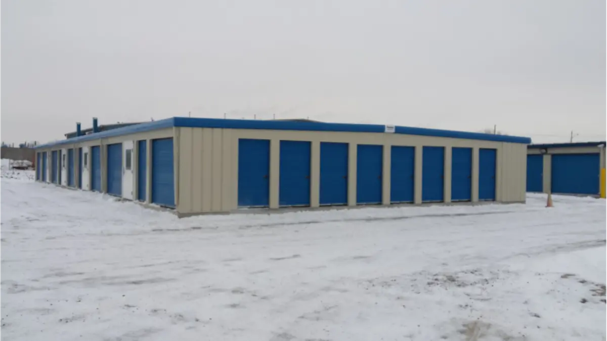 A building with blue doors is surrounded by snow