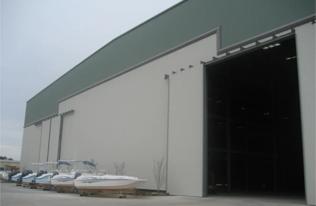 A row of boats are parked in front of a building