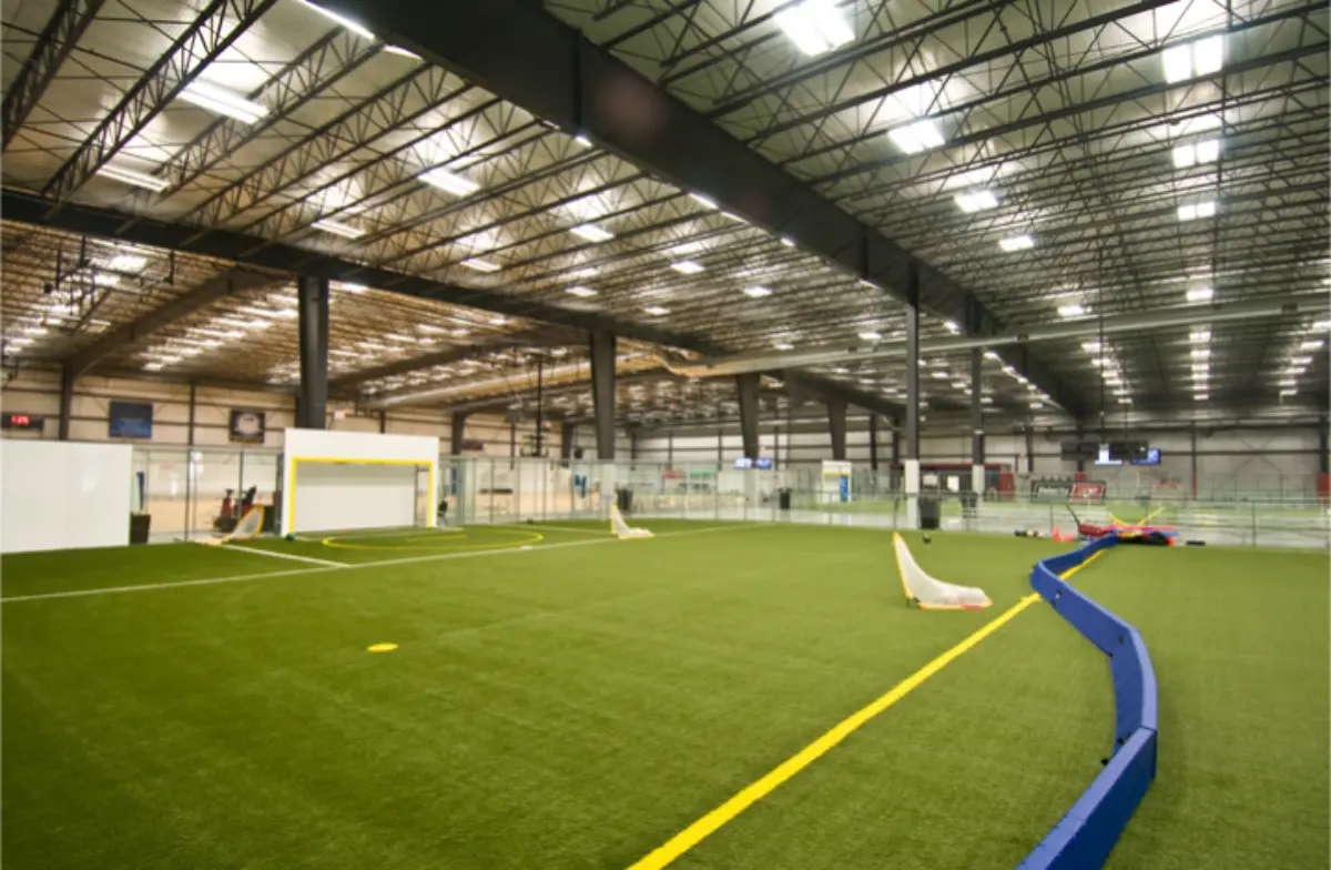 A large indoor soccer field with a yellow line