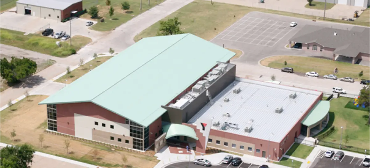 An aerial view of a large building with a green roof