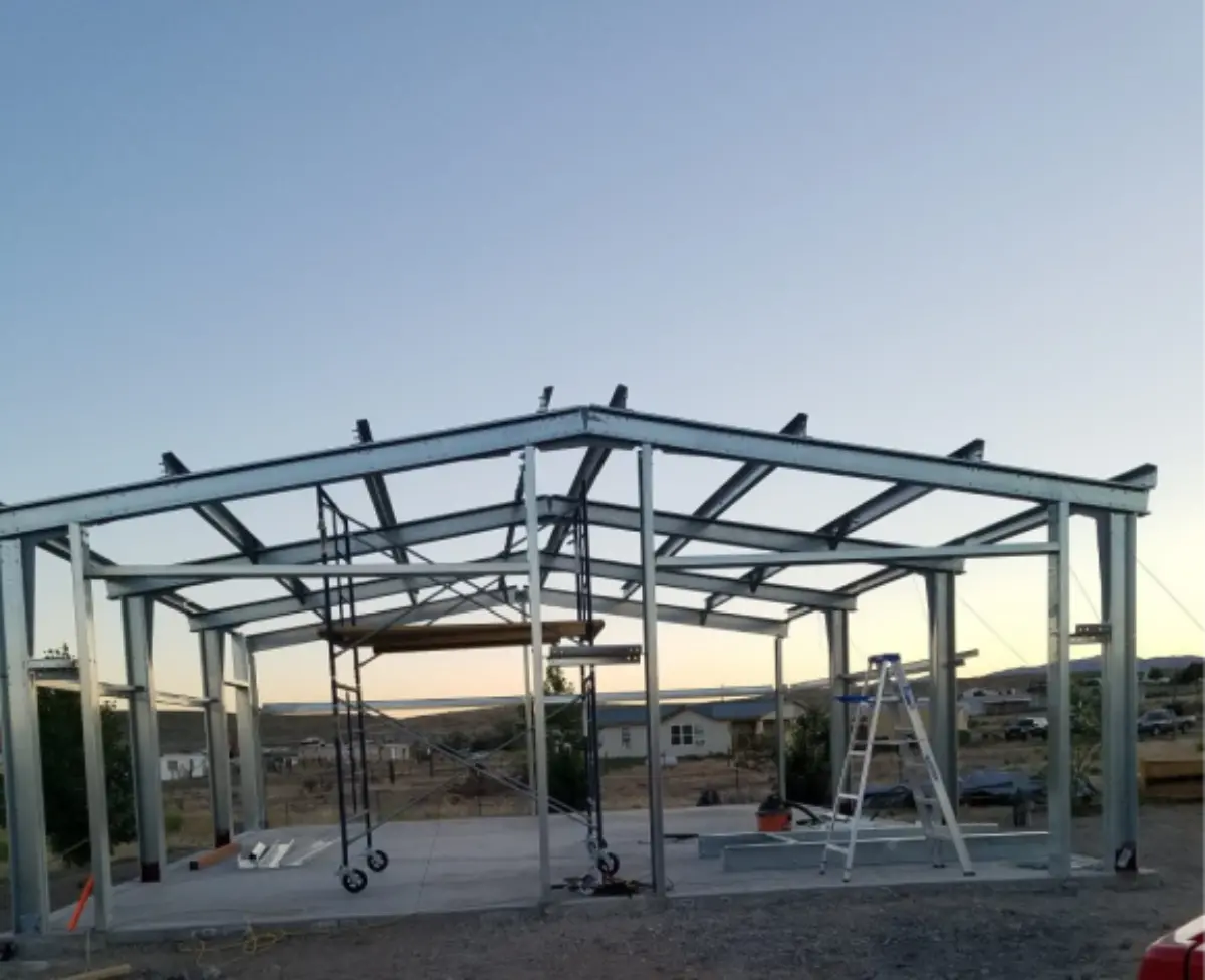 A metal structure is being built with a blue sky in the background