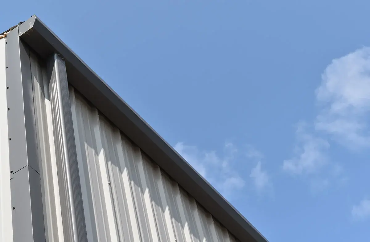 The corner of a building with a blue sky in the background