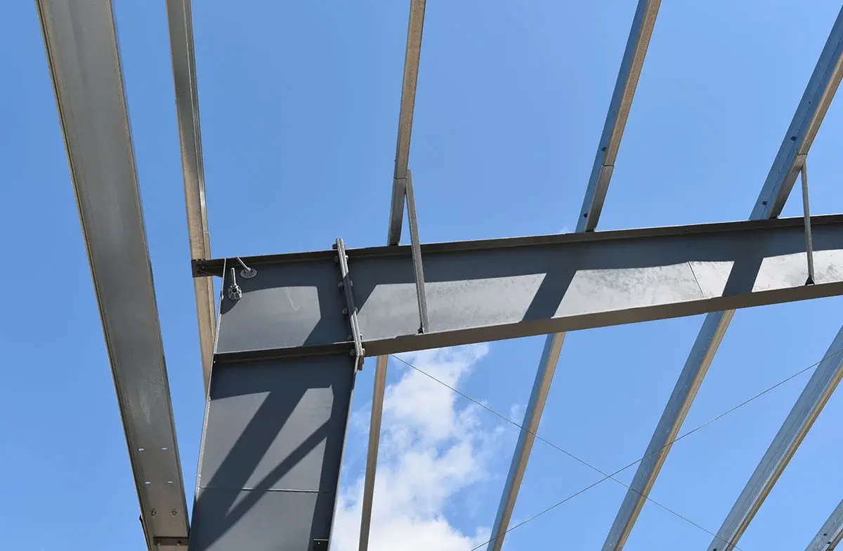 A close up of a metal structure with a blue sky in the background