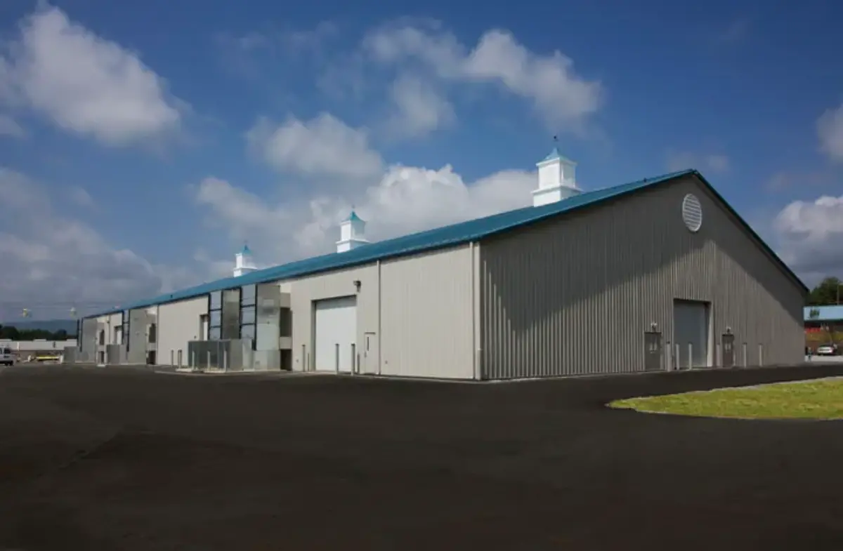 A large building with a blue roof and white chimneys