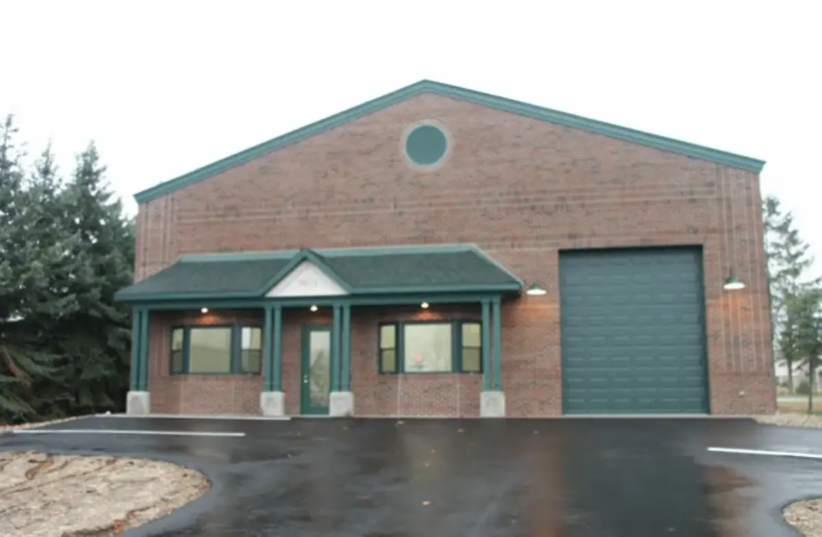 A large brick building with a green garage door