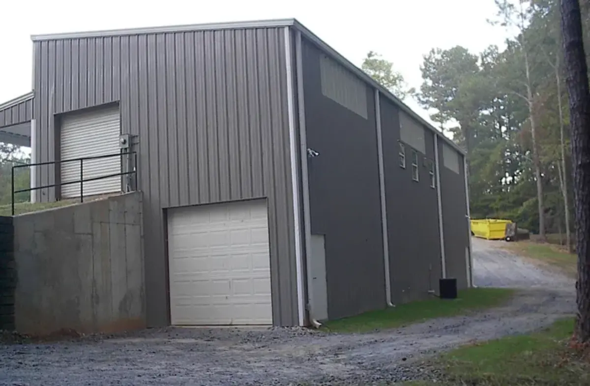 A large metal building with a white garage door
