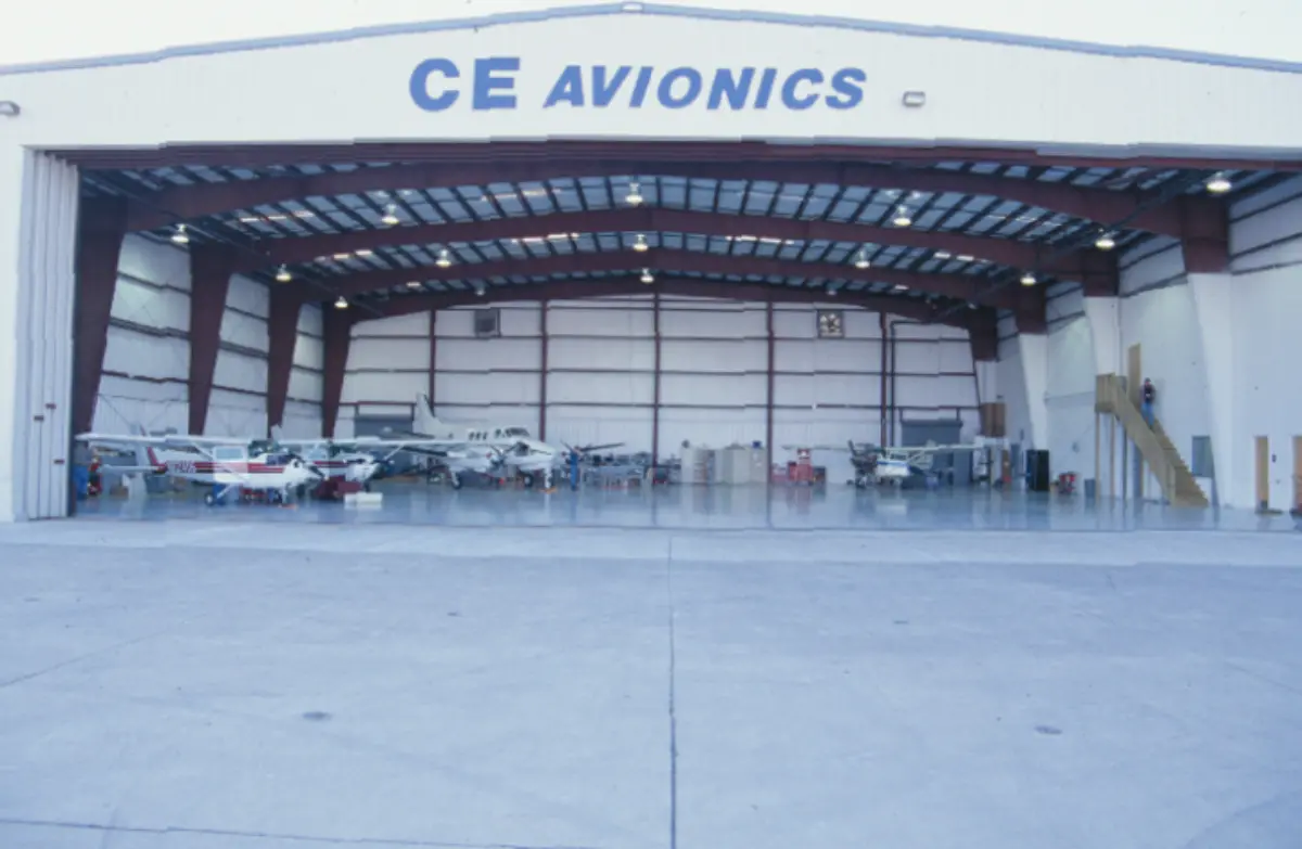 A large hangar with the words ce avionics on it