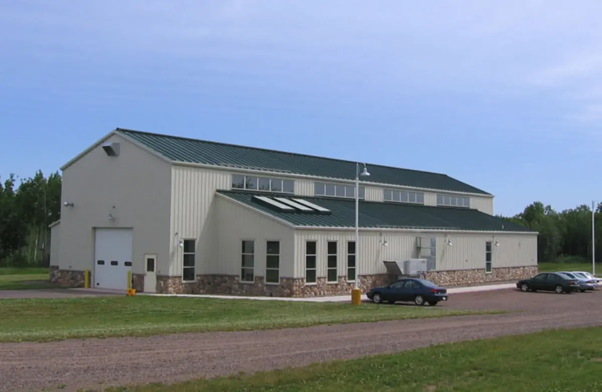 A large white building with a green roof