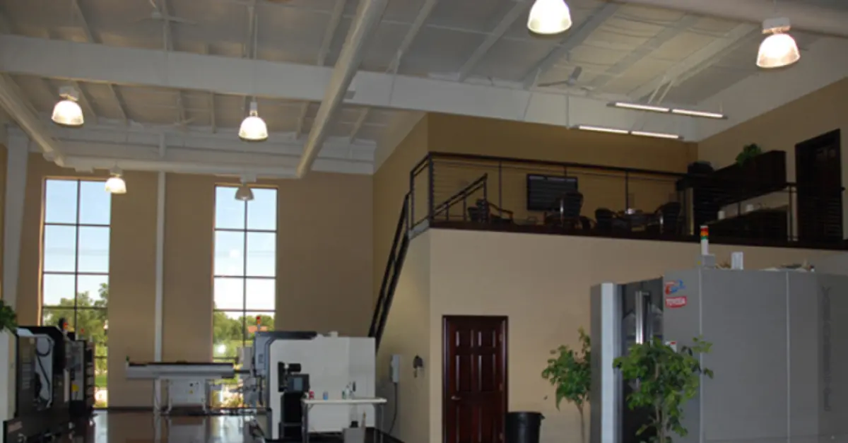 A large room with a balcony and lots of windows