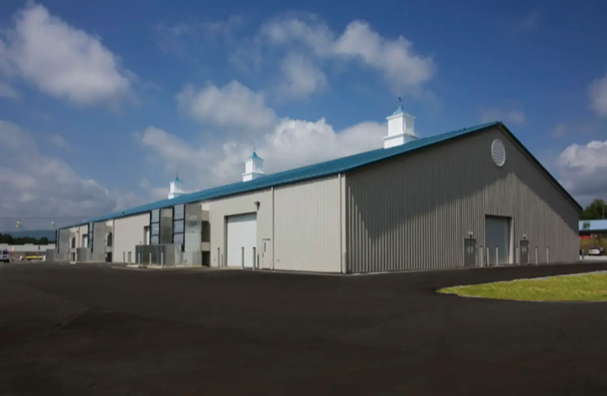 A large building with a blue roof and white chimneys