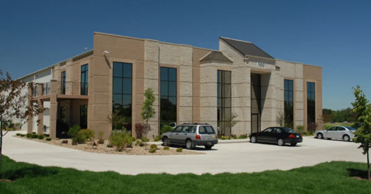 A large building with cars parked in front of it