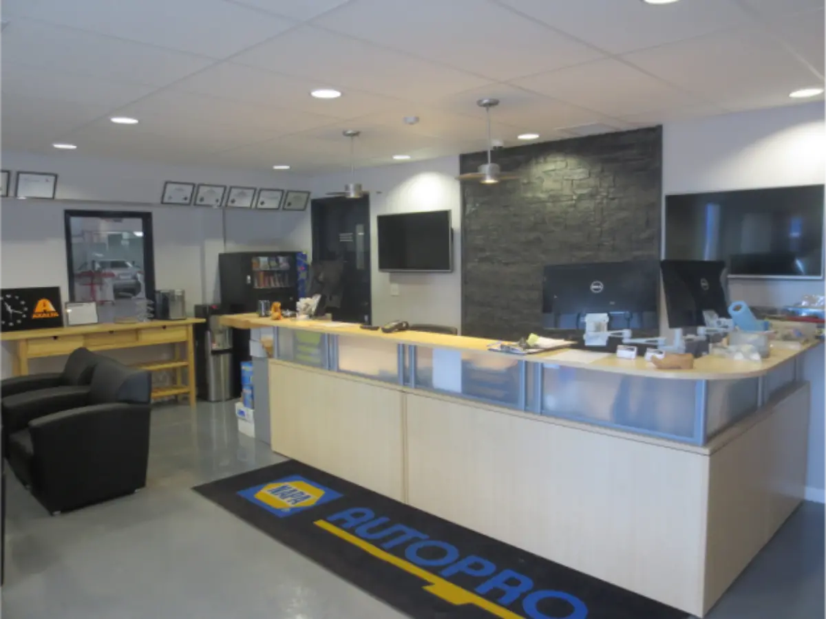 A reception area for autopro with a black mat on the floor