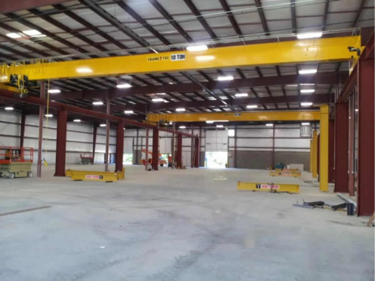 A large warehouse with a yellow crane in the middle