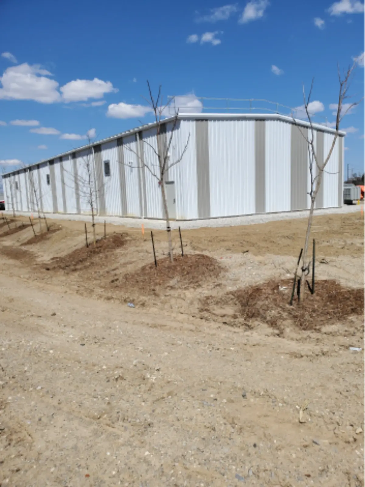 A large white building with trees in front of it