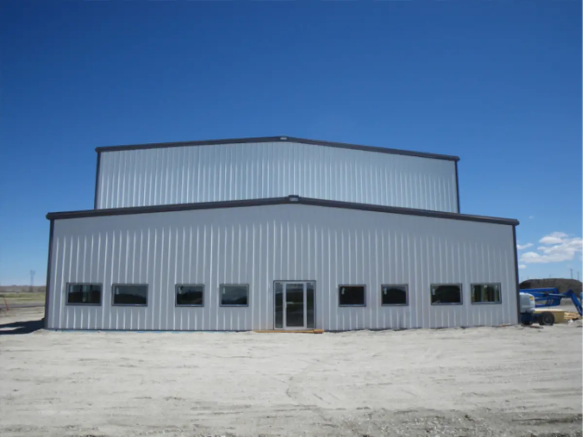 A large white building with a blue sky in the background