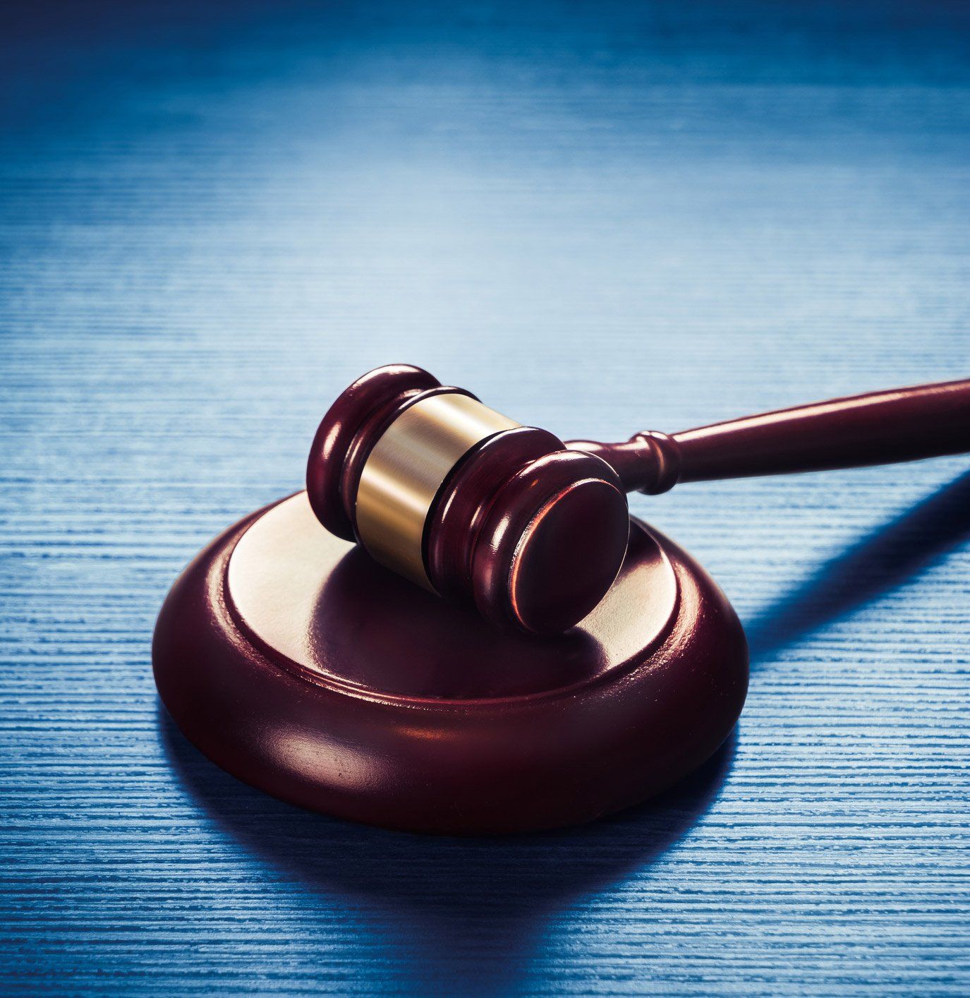 Gavel on a Blue Wooden Table — Beaufort & Charleston, SC — A Bail Now! Bail Bonds Inc.