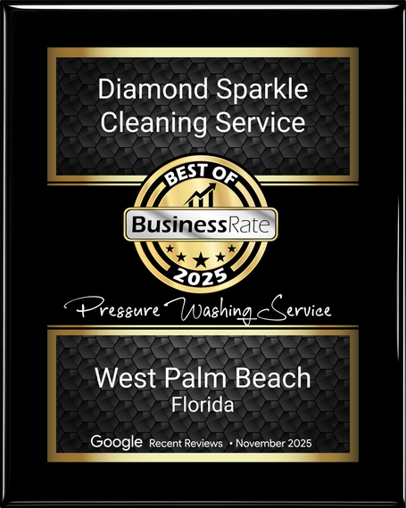 A man in blue overalls and yellow boots is using a high pressure washer.