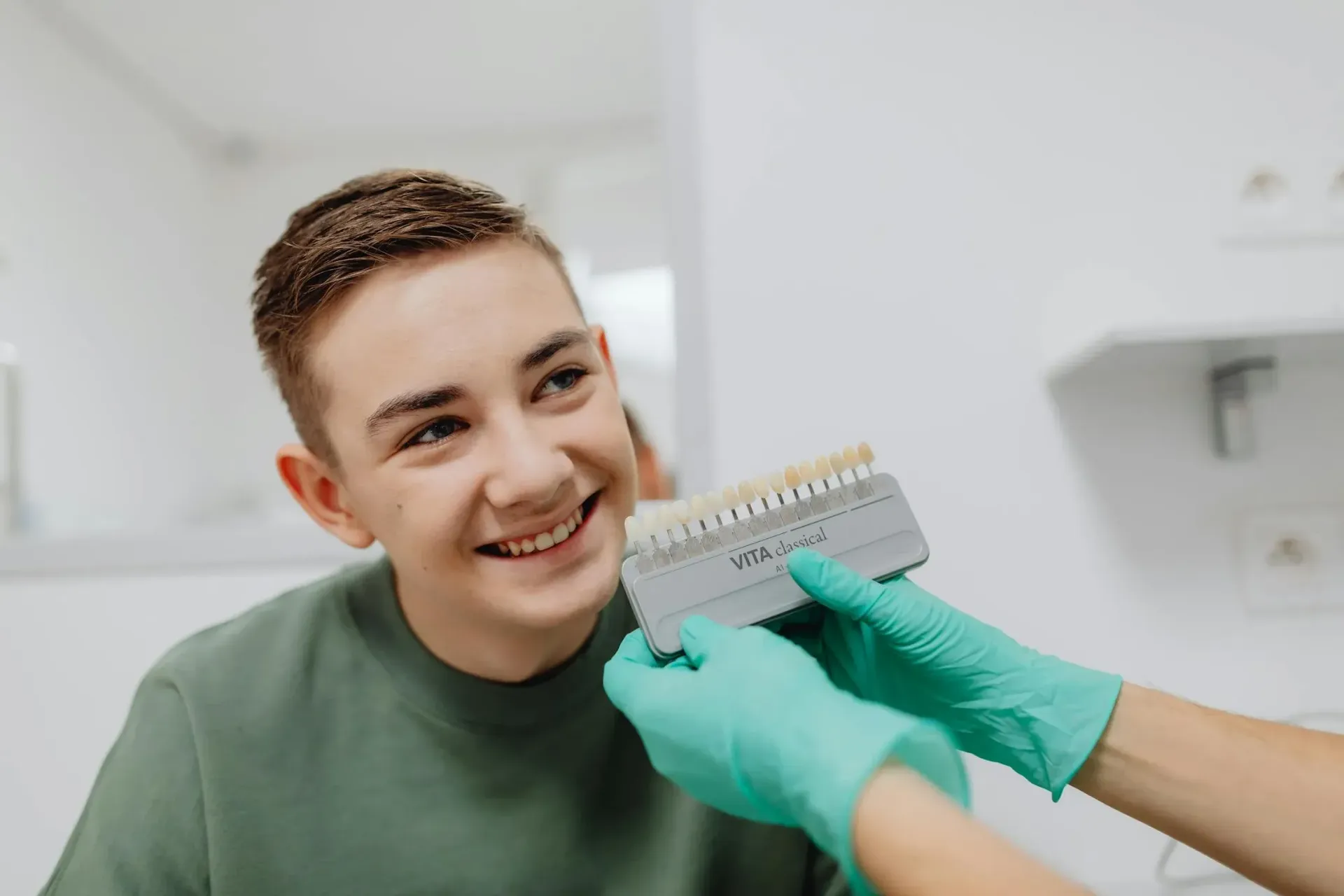 A Dentist Is Brushing A Model Of Teeth With A Toothbrush — Tweed City Dental in Tweed Heads South, NSW