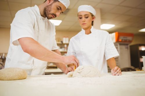 Team of bakers preparing dough