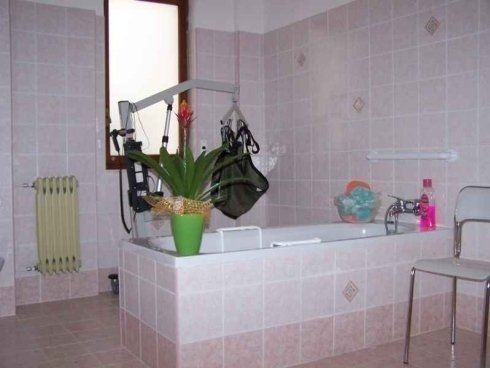 Un bagno con una vasca da bagno e una sedia.