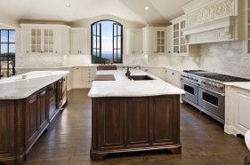 A large kitchen with a large island in the middle of it.